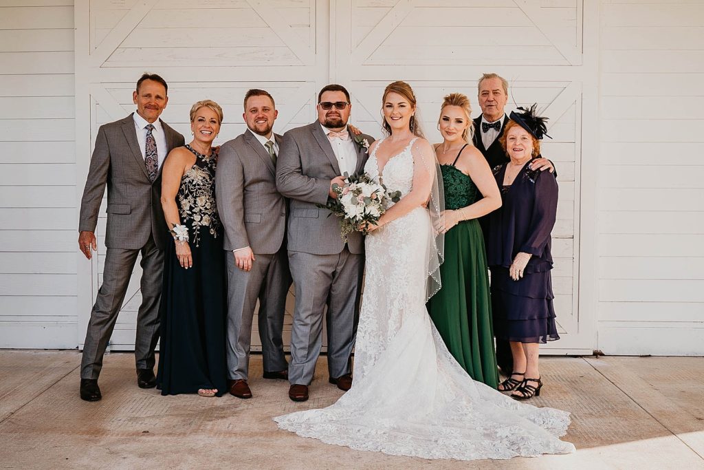 Bride and Groom portrait with family Ever After Farms Wedding Photography captured by South Florida Wedding Photographer Krystal Capone Photography 