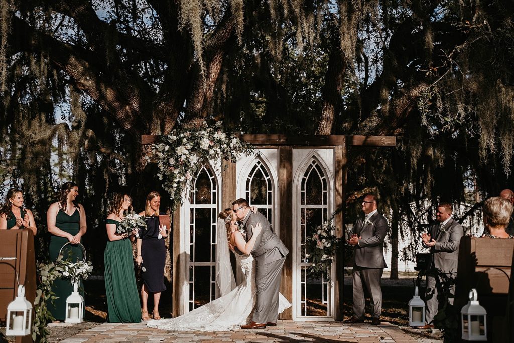 Just married couple kissing during Ceremony Ever After Farms Wedding Photography captured by South Florida Wedding Photographer Krystal Capone Photography 