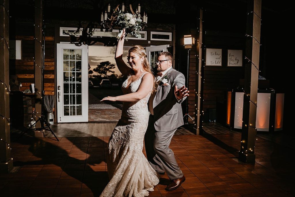 Bride and Groom having a fun entrance into the Reception Ever After Farms Wedding Photography captured by South Florida Wedding Photographer Krystal Capone Photography 