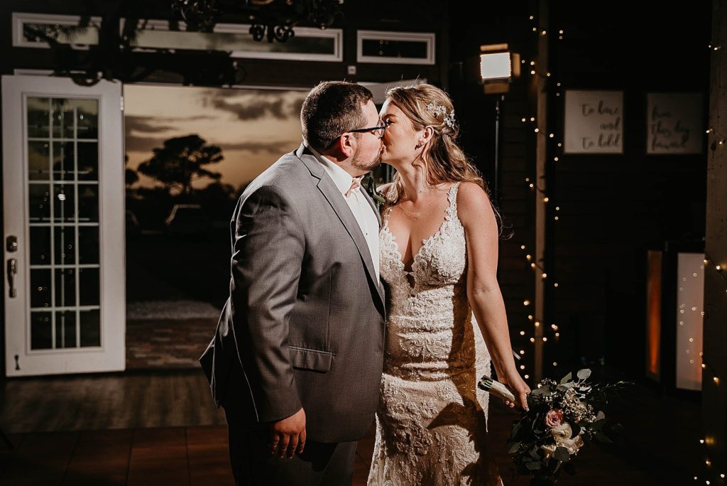 Bride and Groom kissing during entrance to Reception Ever After Farms Wedding Photography captured by South Florida Wedding Photographer Krystal Capone Photography 
