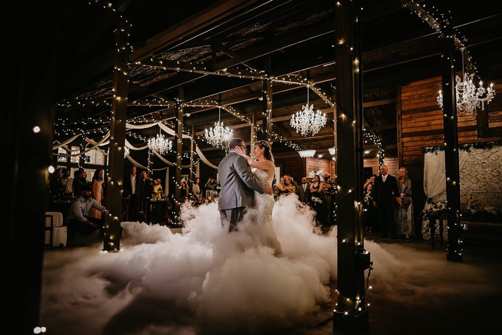 Bride and Groom having their first dance with dry ice smoke Ever After Farms Wedding Photography captured by South Florida Wedding Photographer Krystal Capone Photography 