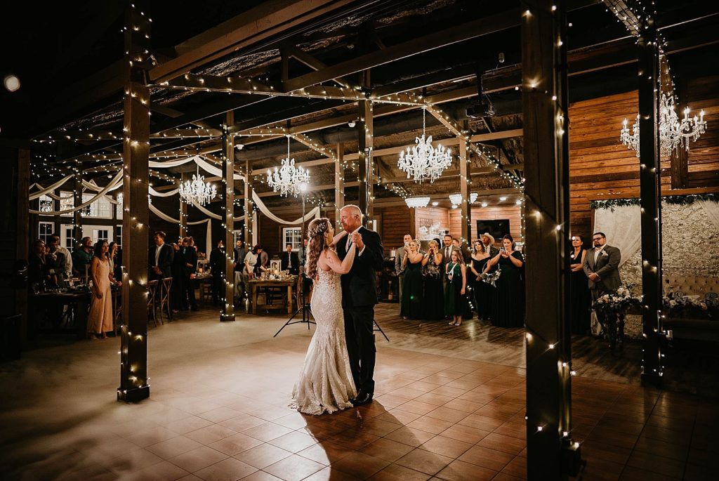 Father daughter dance in rustic farm with guests watching Ever After Farms Wedding Photography captured by South Florida Wedding Photographer Krystal Capone Photography 