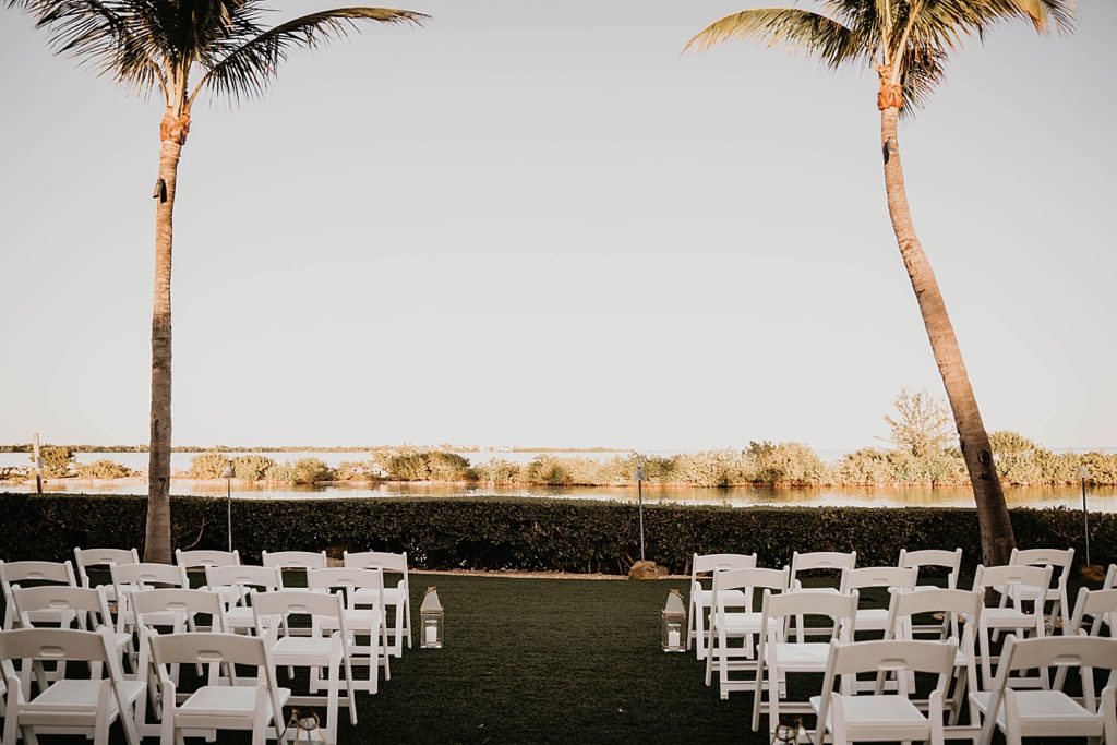 Ceremony area detail shot with white folding chairs outdoors Hawks Cay Resort Wedding Photography captured by South Florida Wedding Photographer Krystal Capone Photography 
