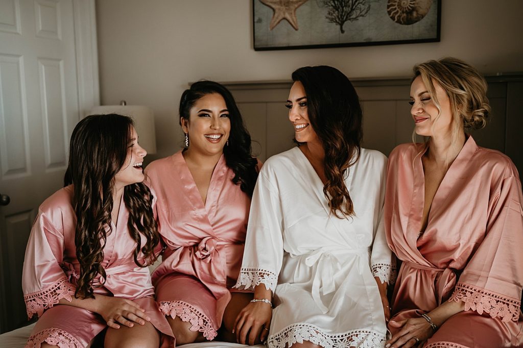 Bride with bridesmaids before getting readyin silk robes Hawks Cay Resort Wedding Photography captured by South Florida Wedding Photographer Krystal Capone Photography 
