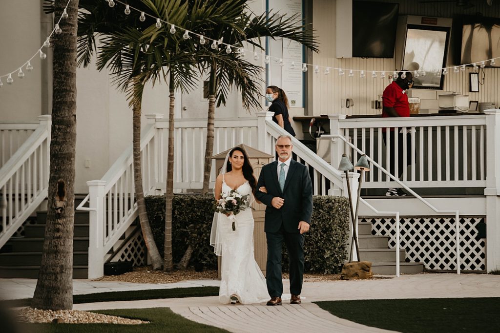 Ceremony Bride and father arm in arm walking into the ceremony Hawks Cay Resort Wedding Photography captured by South Florida Wedding Photographer Krystal Capone Photography