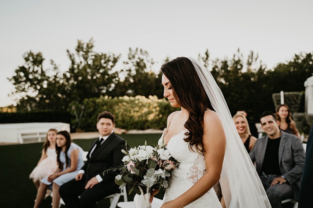 Bride reaction entering Ceremony with bouquet with wedding attendee looking Hawks Cay Resort Wedding Photography captured by South Florida Wedding Photographer Krystal Capone Photography