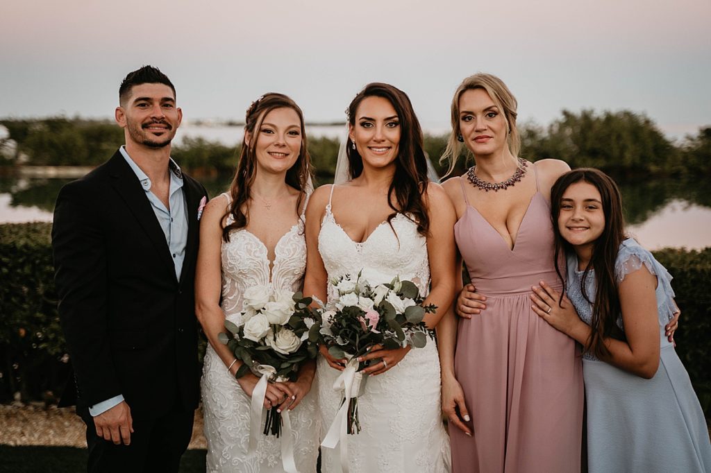 Brides with bouquets and friends and family Hawks Cay Resort Wedding Photography captured by South Florida Wedding Photographer Krystal Capone Photography