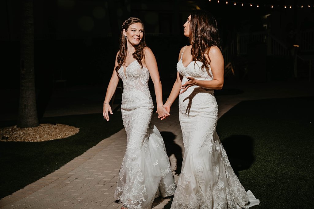 Brides holding hands looking at each other at night Hawks Cay Resort Wedding Photography captured by South Florida Wedding Photographer Krystal Capone Photography