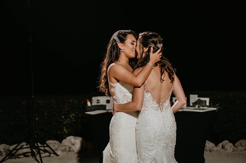 Bride pulling each other in to kiss in the night Hawks Cay Resort Wedding Photography captured by South Florida Wedding Photographer Krystal Capone Photography