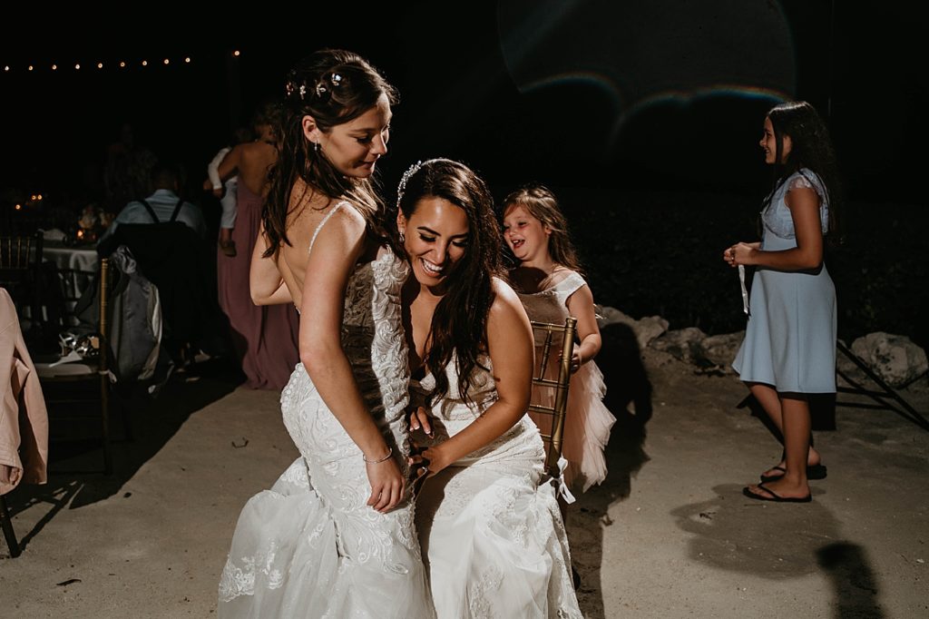 Brides dancing close against each other during nighttime Reception Hawks Cay Resort Wedding Photography captured by South Florida Wedding Photographer Krystal Capone Photography