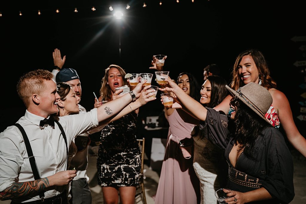 Wedding attendees toasting at Reception Hawks Cay Resort Wedding Photography captured by South Florida Wedding Photographer Krystal Capone Photography