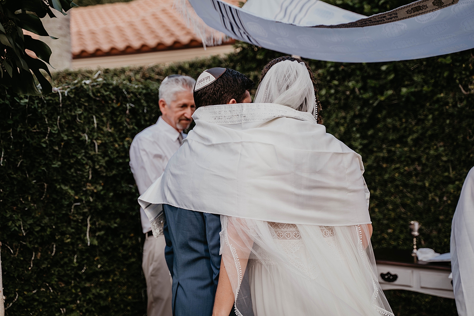Bride and Groom wrapped in Prayer shawl Ceremony Intimate South Florida Wedding Photography captured by South Florida Wedding Photographer Krystal Capone Photography 