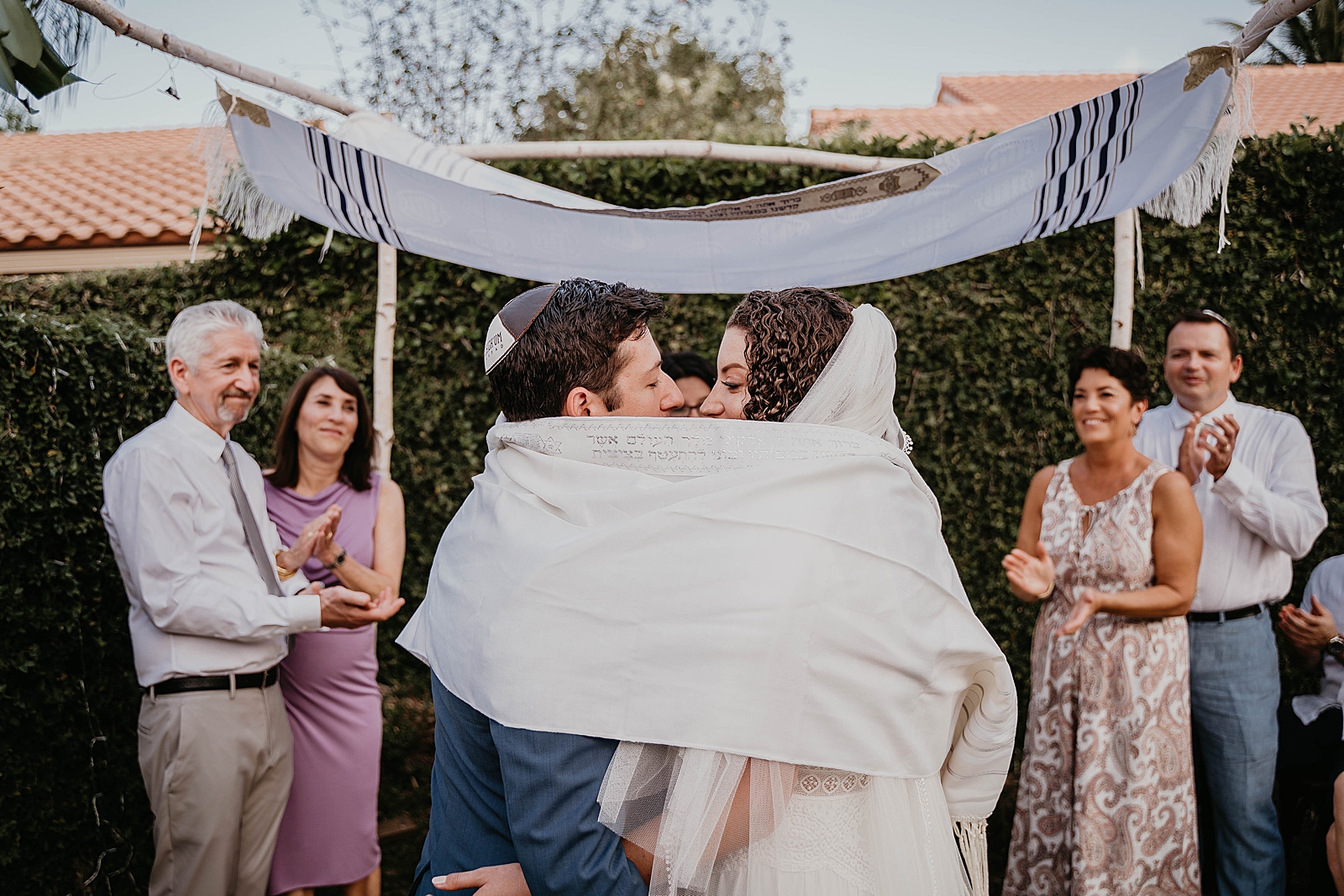Bride and Groom facing each other wrapped in Prayer shawl Intimate South Florida Wedding Photography captured by South Florida Wedding Photographer Krystal Capone Photography 