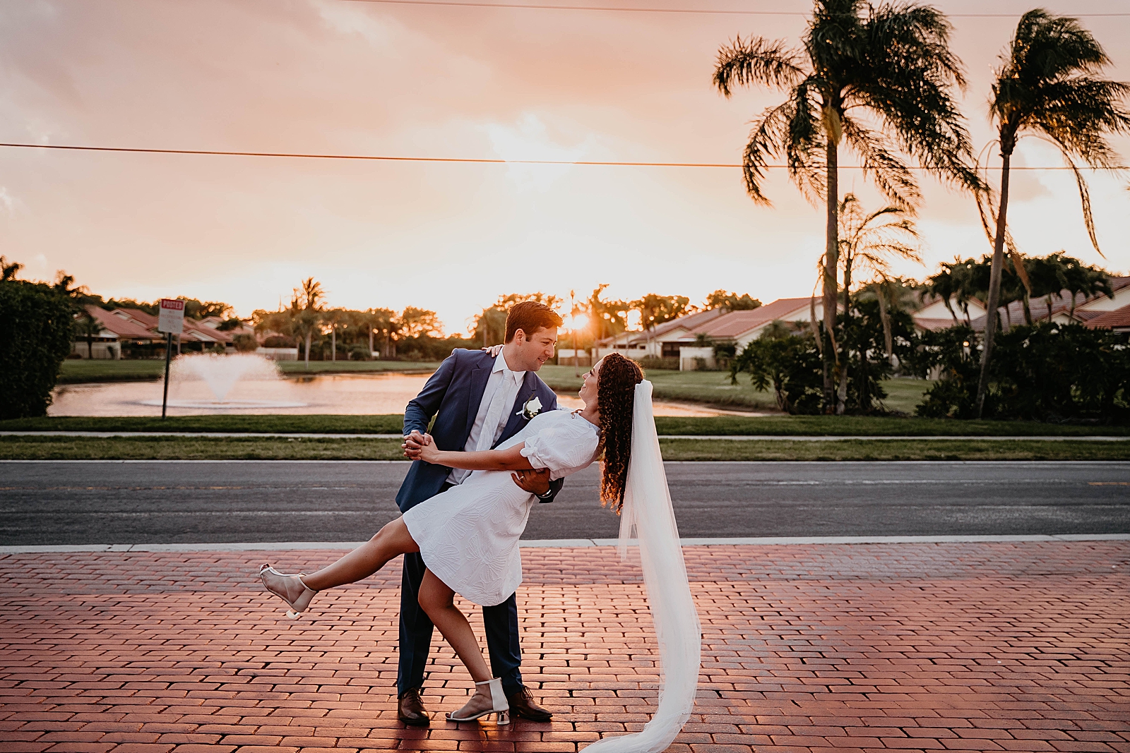 Groom dipping Bride as sunsets in beautiful Palm Beach neighborhood Intimate South Florida Wedding Photography captured by South Florida Wedding Photographer Krystal Capone Photography 