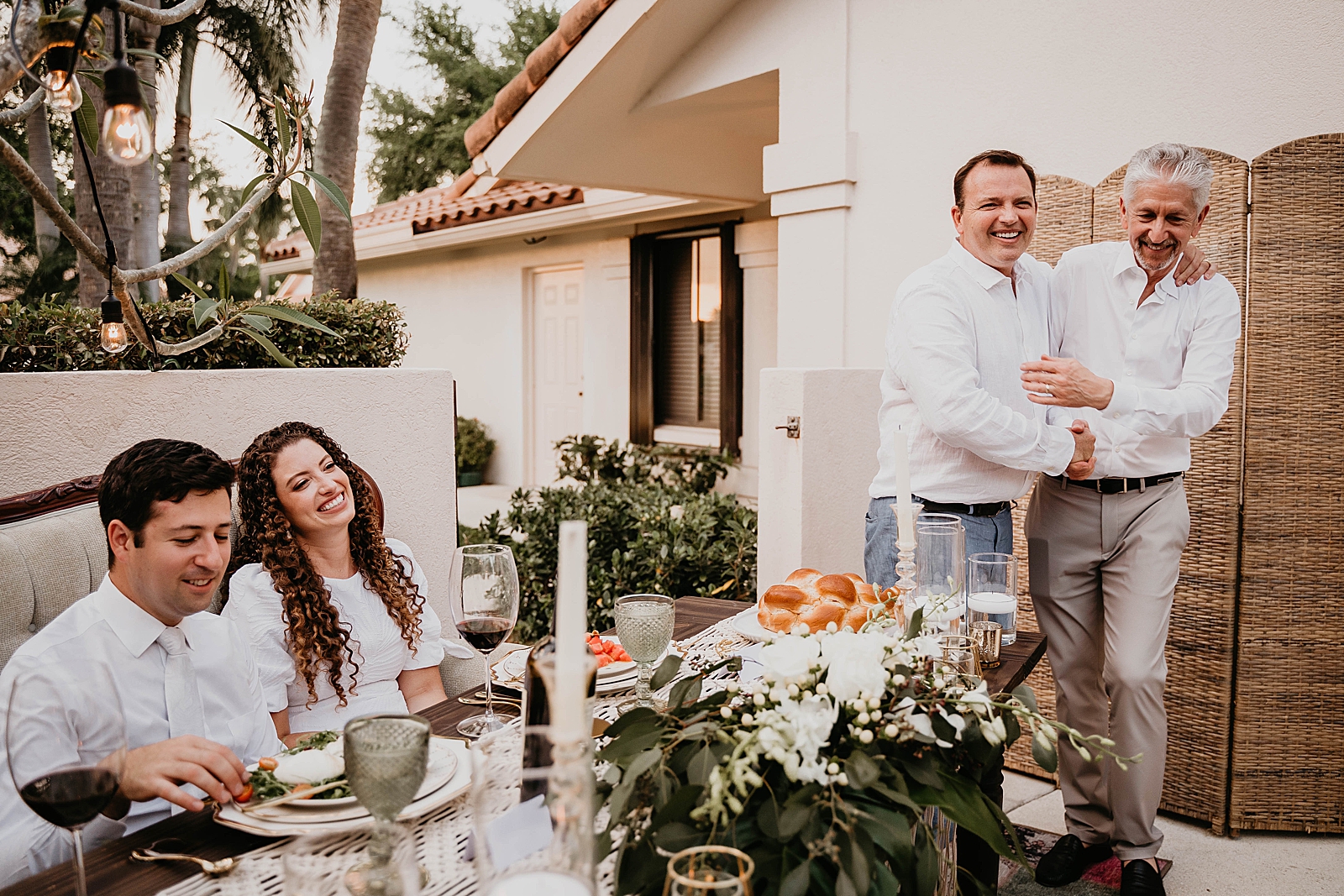 Bride and Groom listening to Fathers with challah on sweetheart table Intimate South Florida Wedding Photography captured by South Florida Wedding Photographer Krystal Capone Photography 