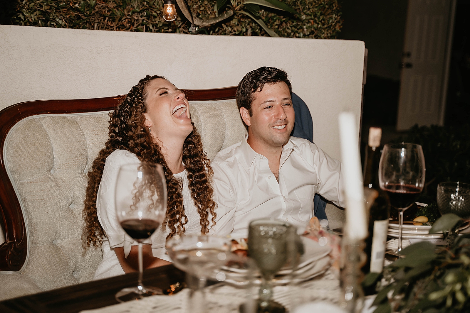 Bride and Groom laughing at sweetheart table Intimate South Florida Wedding Photography captured by South Florida Wedding Photographer Krystal Capone Photography 