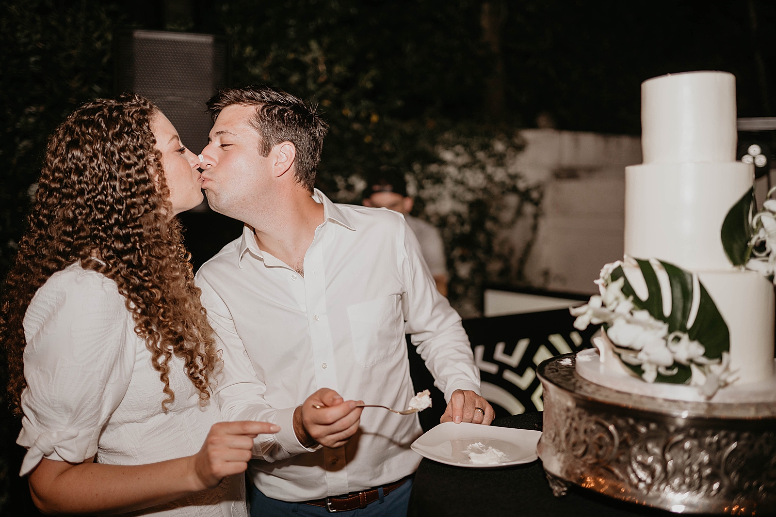 Bride and Groom kissing after cake cutting and tasting Intimate South Florida Wedding Photography captured by South Florida Wedding Photographer Krystal Capone Photography 