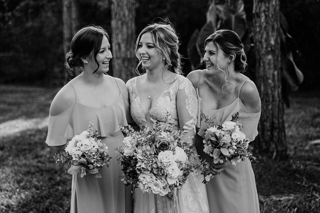 B&W Bride with her Bridesmaids holding Bouquets Intimate South Florida Wedding Photography captured by South Florida Wedding Photographer Krystal Capone Photography 