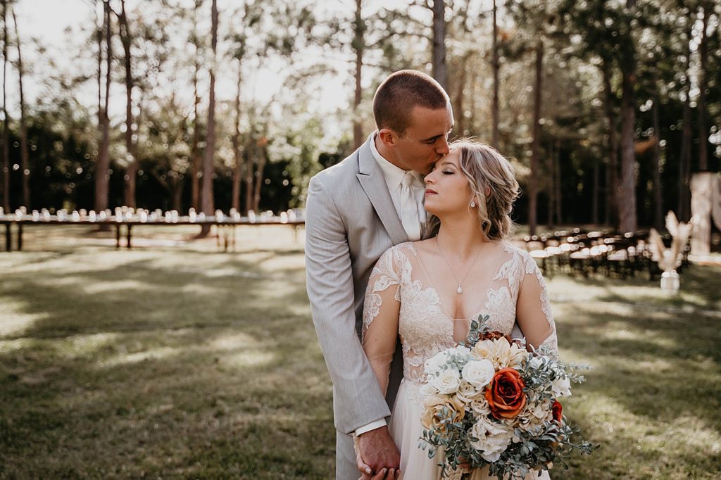 Groom kissing Bride on forehead outside in the forest Intimate South Florida Wedding Photography captured by South Florida Wedding Photographer Krystal Capone Photography 