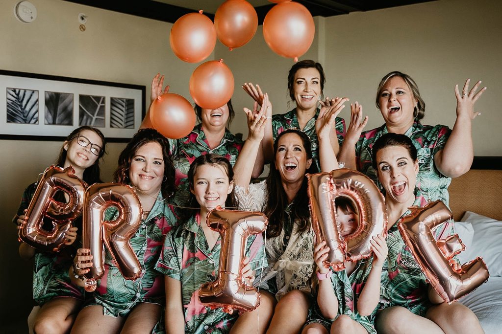 Bride and Bridesmaids before getting ready with balloons and Bride balloon Jupiter Beach Resort Wedding Photography captured by South Florida Wedding Photographer Krystal Capone Photography 