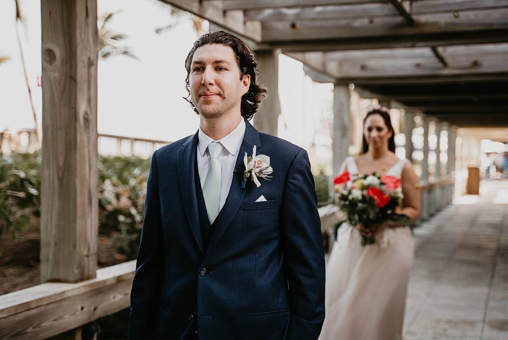 Groom with back turned and Bride approaching for First Look Jupiter Beach Resort Wedding Photography captured by South Florida Wedding Photographer Krystal Capone Photography 