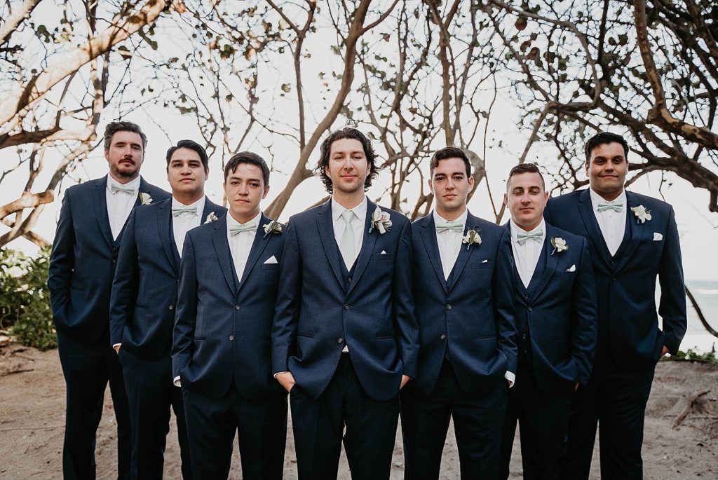 Groom standing with groomsmen on the sand Jupiter Beach Resort Wedding Photography captured by South Florida Wedding Photographer Krystal Capone Photography 