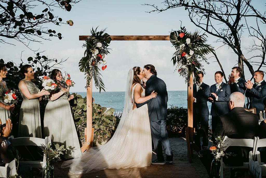 Just married Bride and Groom kissing ceremony Jupiter Beach Resort Wedding Photography captured by South Florida Wedding Photographer Krystal Capone Photography 