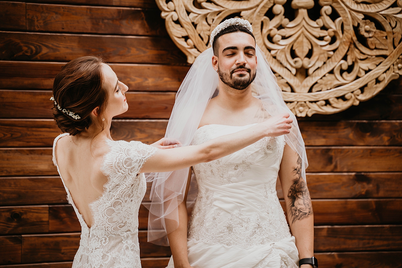 Bride posing veil of quirky backup male Bride its a prank Living Sculptures Sanctuary Wedding Photography captured by South Florida Wedding Photographer Krystal Capone Photography 