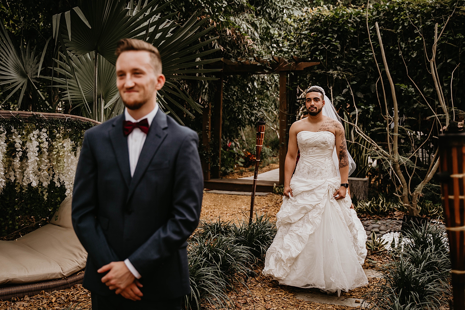 Groom with back turned and decoy Bride approaching its just a prank bro Living Sculptures Sanctuary Wedding Photography captured by South Florida Wedding Photographer Krystal Capone Photography 