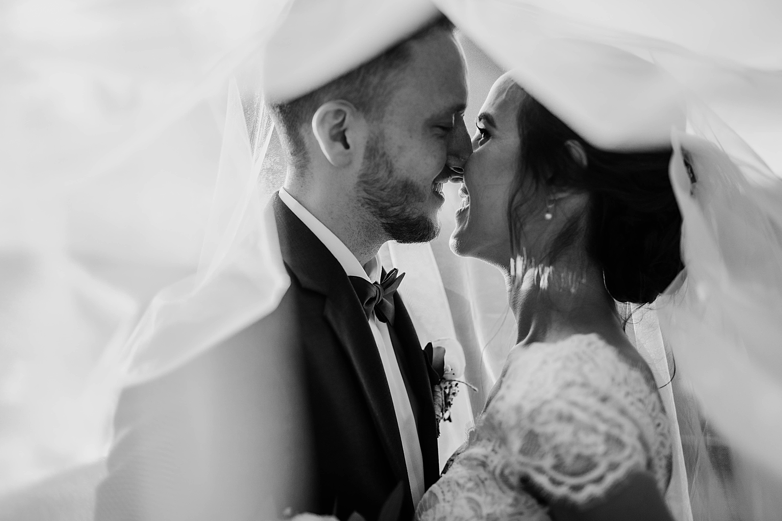 B&W Bride and Groom about to kiss underneath the veil Living Sculptures Sanctuary Wedding Photography captured by South Florida Wedding Photographer Krystal Capone Photography 