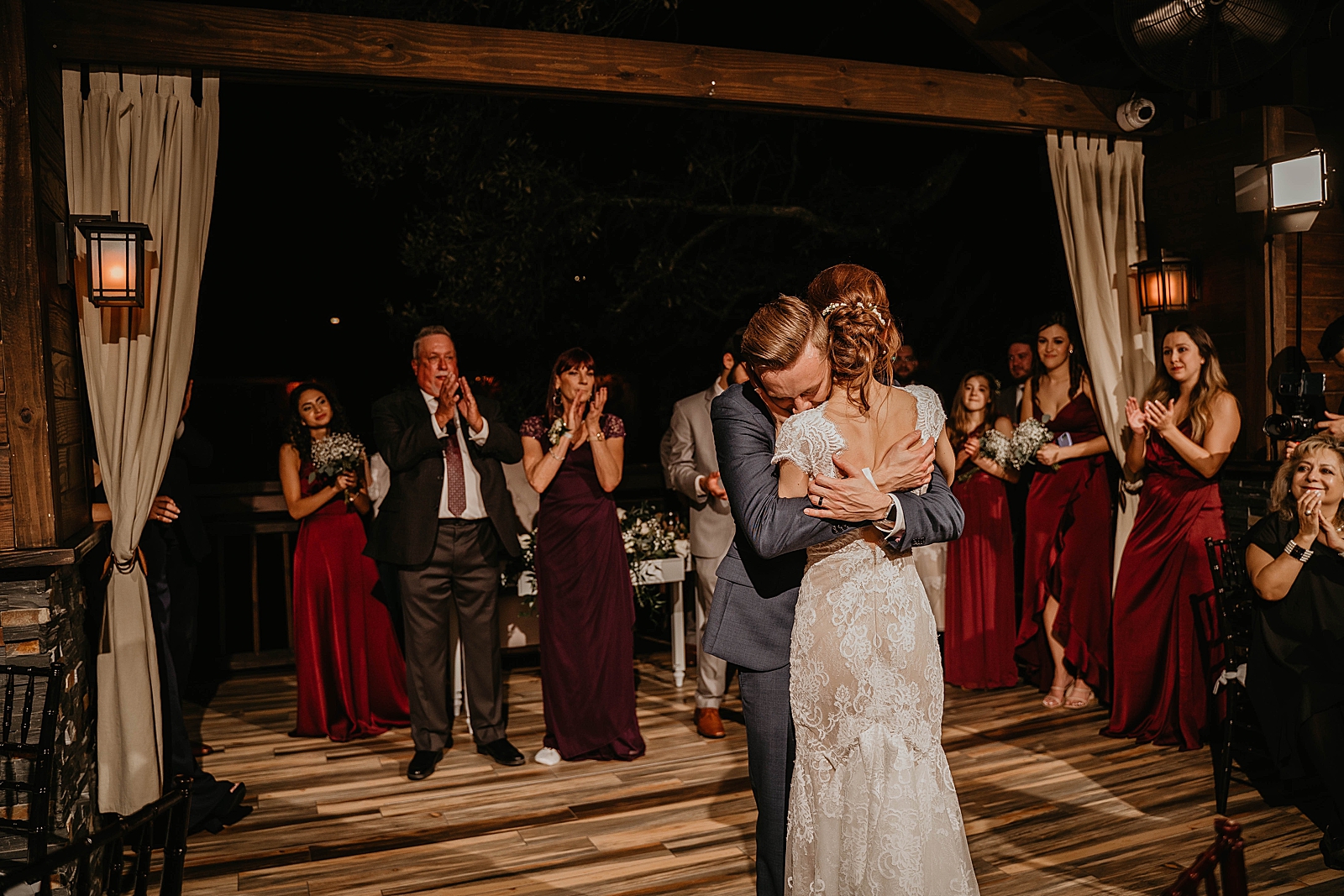 Bride and Groom hugging each other after First dance with attendees clapping Living Sculptures Sanctuary Wedding Photography captured by South Florida Wedding Photographer Krystal Capone Photography 