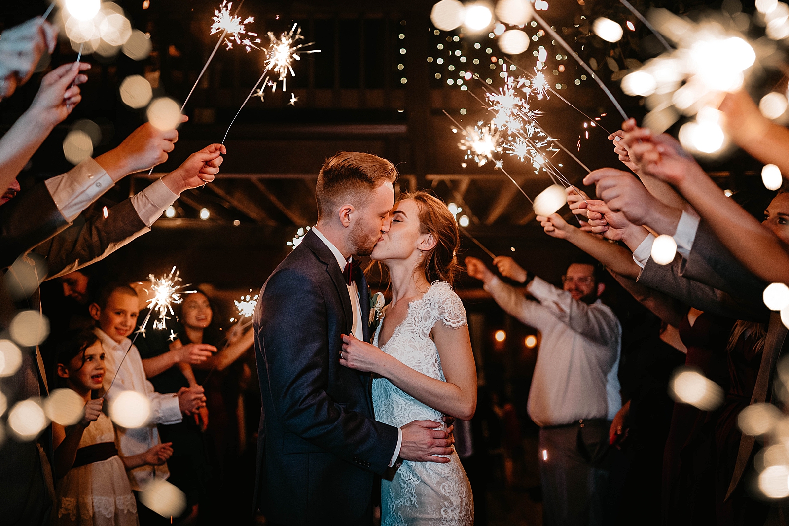 Bride and Groom kissing during sparkler exit Living Sculptures Sanctuary Wedding Photography captured by South Florida Wedding Photographer Krystal Capone Photography 