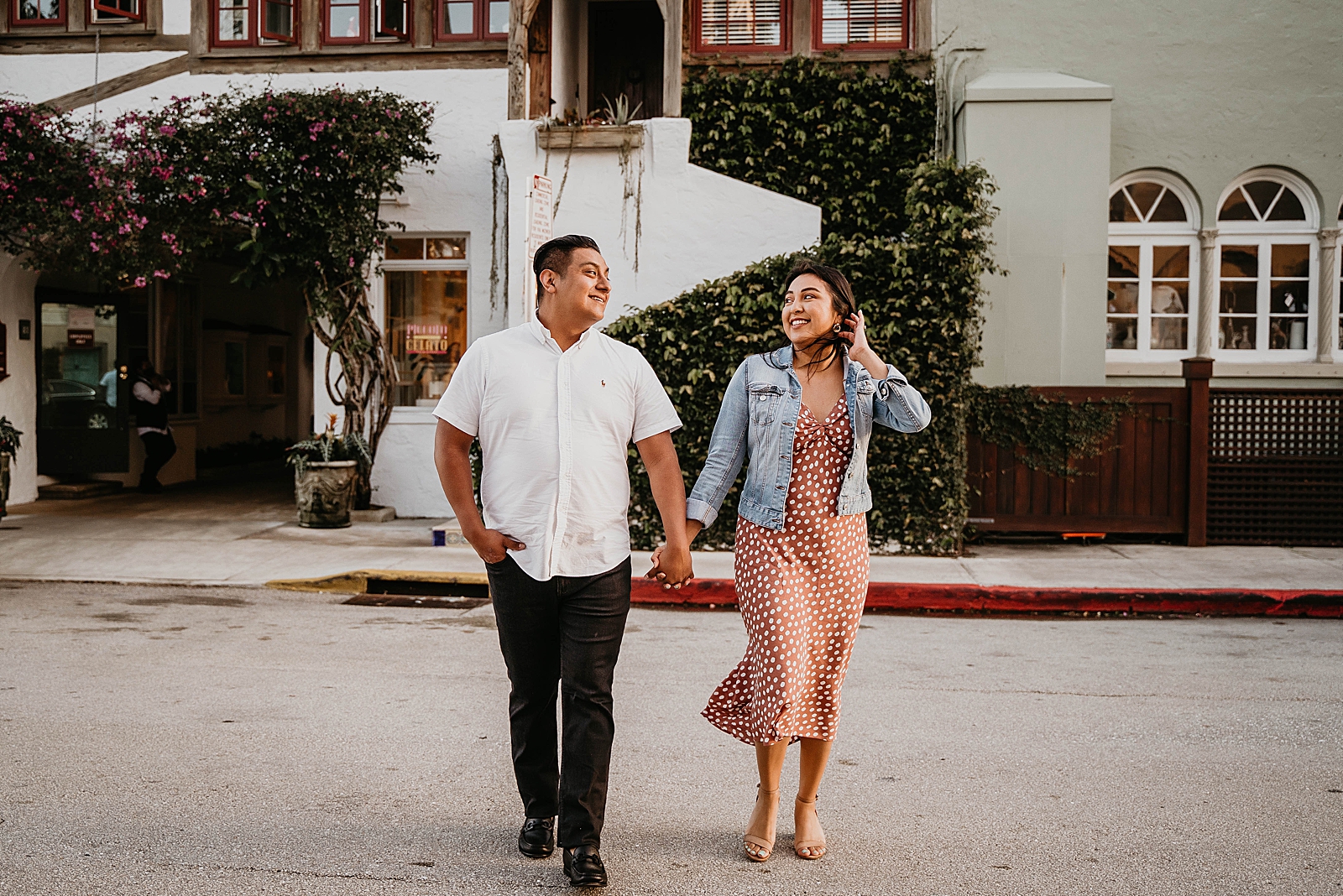 Couple holding hands and looking at each other on the street Palm Beach Island Engagement Photography captured by South Florida Engagement Photographer Krystal Capone Photography 