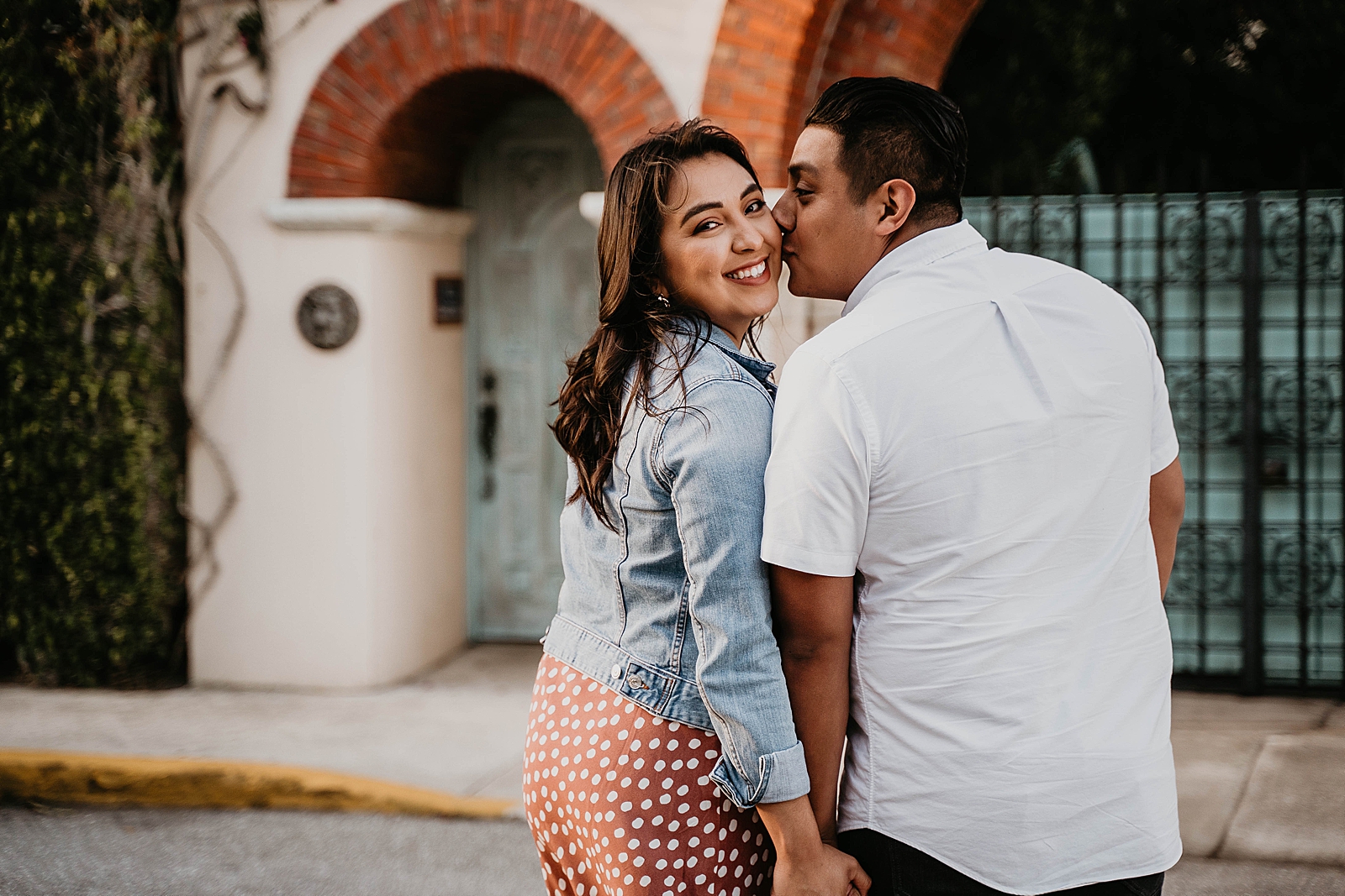 Man kisses woman on her cheek as they hold hands Palm Beach Island Engagement Photography captured by South Florida Engagement Photographer Krystal Capone Photography 