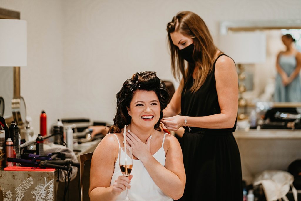 Bride getting ready having her hair done by hair stylist Pelican Club Wedding Photography captured by South Florida Wedding Photographer Krystal Capone Photography 
