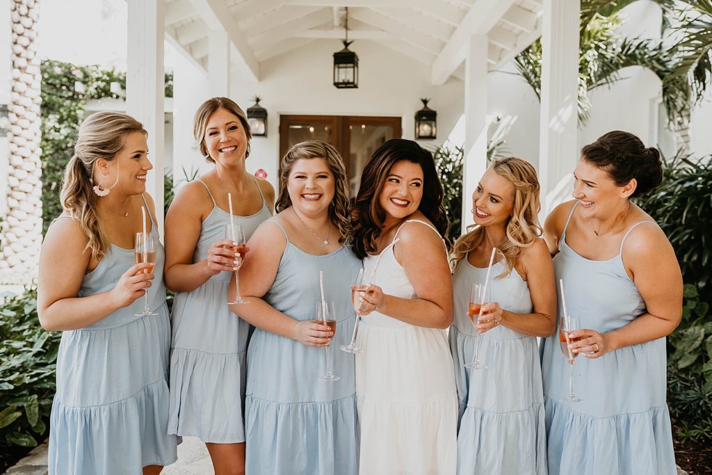Bride and Bridesmaids having a drink outside Pelican Club Wedding Photography captured by South Florida Wedding Photographer Krystal Capone Photography 