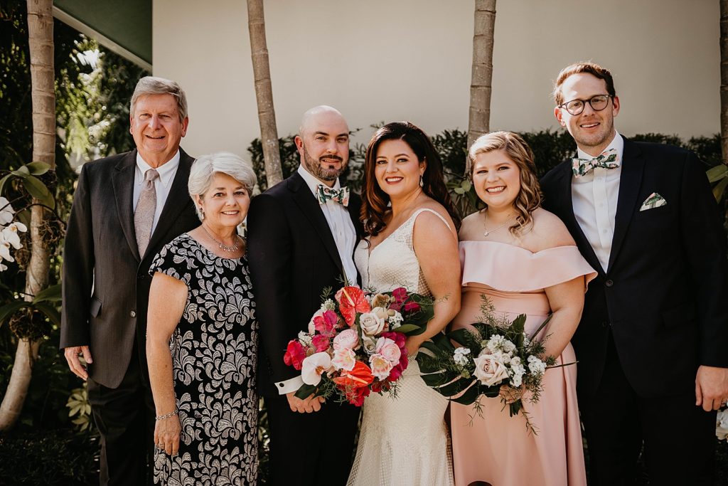 Bride and Groom portrait with family Pelican Club Wedding Photography captured by South Florida Wedding Photographer Krystal Capone Photography 