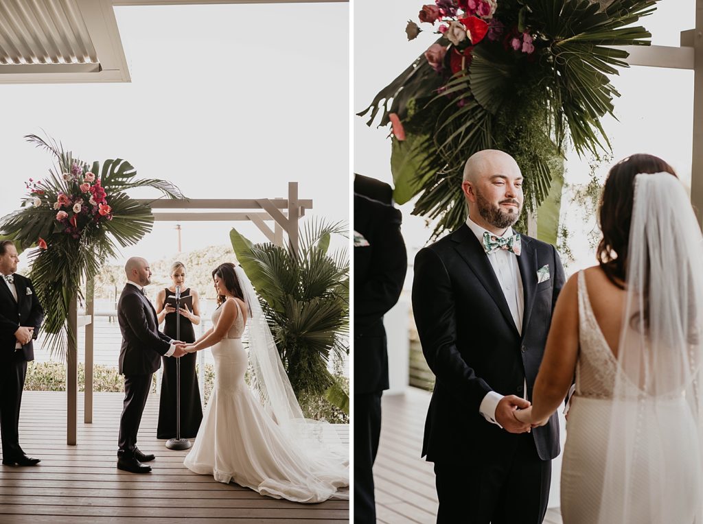 Bride and Groom holding hands during Homily with tropical greens on arch Pelican Club Wedding Photography captured by South Florida Wedding Photographer Krystal Capone Photography 