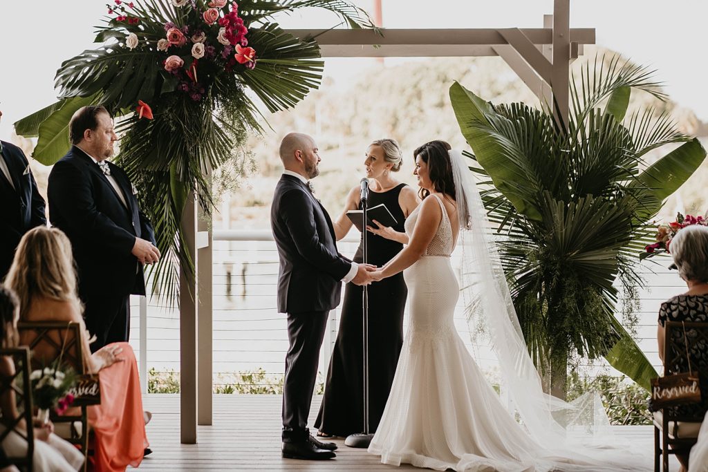 Officiant leading Bride and Groom through I do's Ceremony Pelican Club Wedding Photography captured by South Florida Wedding Photographer Krystal Capone Photography 