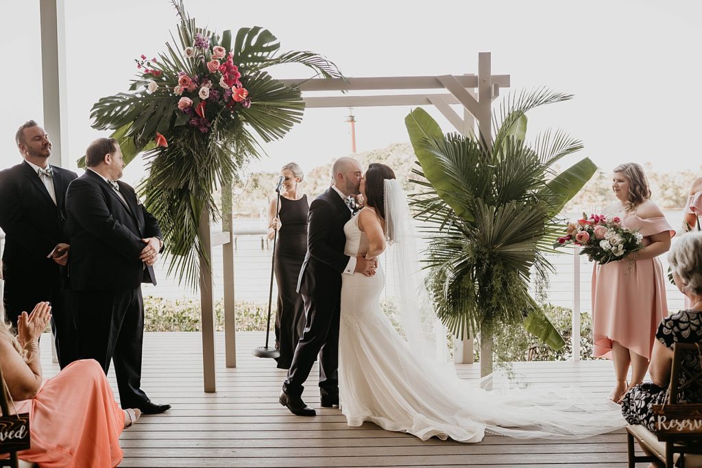 Just married Bride and Groom kissing Ceremony Pelican Club Wedding Photography captured by South Florida Wedding Photographer Krystal Capone Photography 