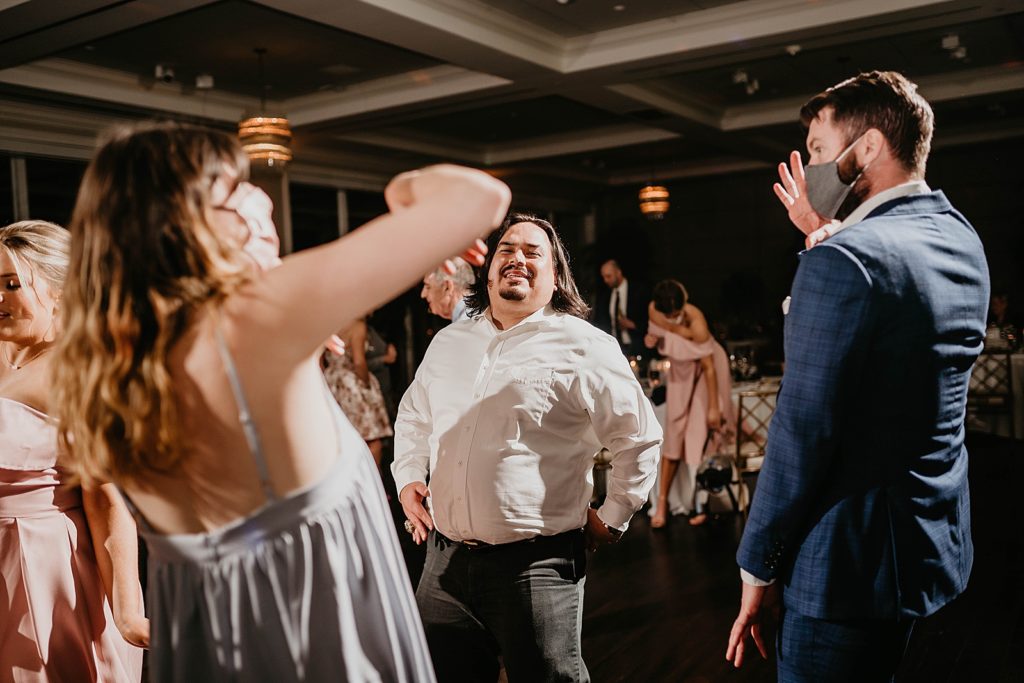 Dancing at the reception with masks on Pelican Club Wedding Photography captured by South Florida Wedding Photographer Krystal Capone Photography 