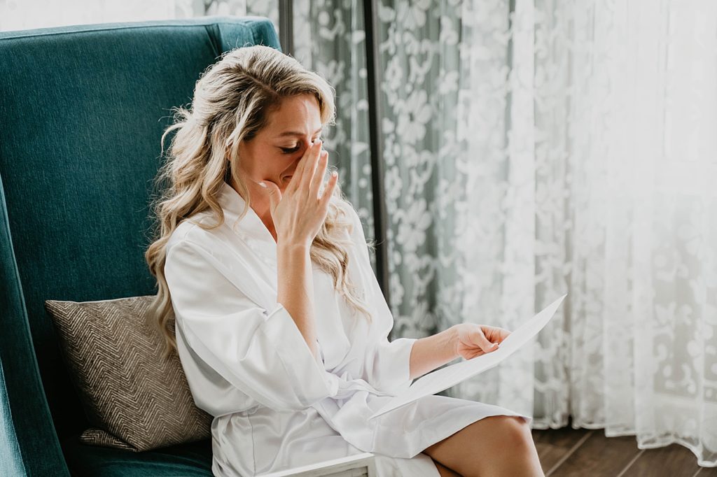 Bride Reading letter before getting ready Pelican Club Wedding Photography captured by South Florida Wedding Photographer Krystal Capone Photography