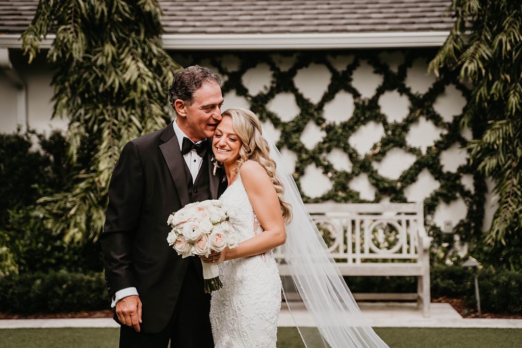 Father hugging Bride after first look Pelican Club Wedding Photography captured by South Florida Wedding Photographer Krystal Capone Photography