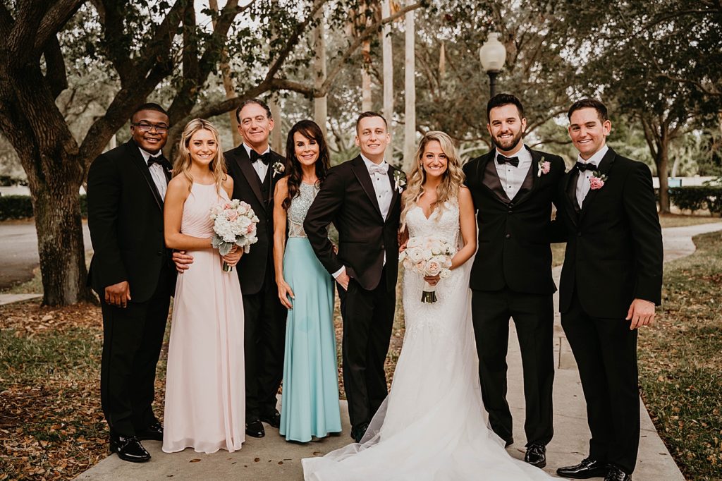 Bride and Groom portrait with friends and family Pelican Club Wedding Photography captured by South Florida Wedding Photographer Krystal Capone Photography