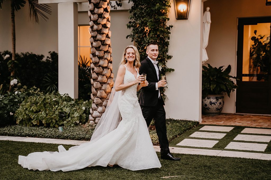 Bride and Groom entering Reception together with Champaign Pelican Club Wedding Photography captured by South Florida Wedding Photographer Krystal Capone Photography