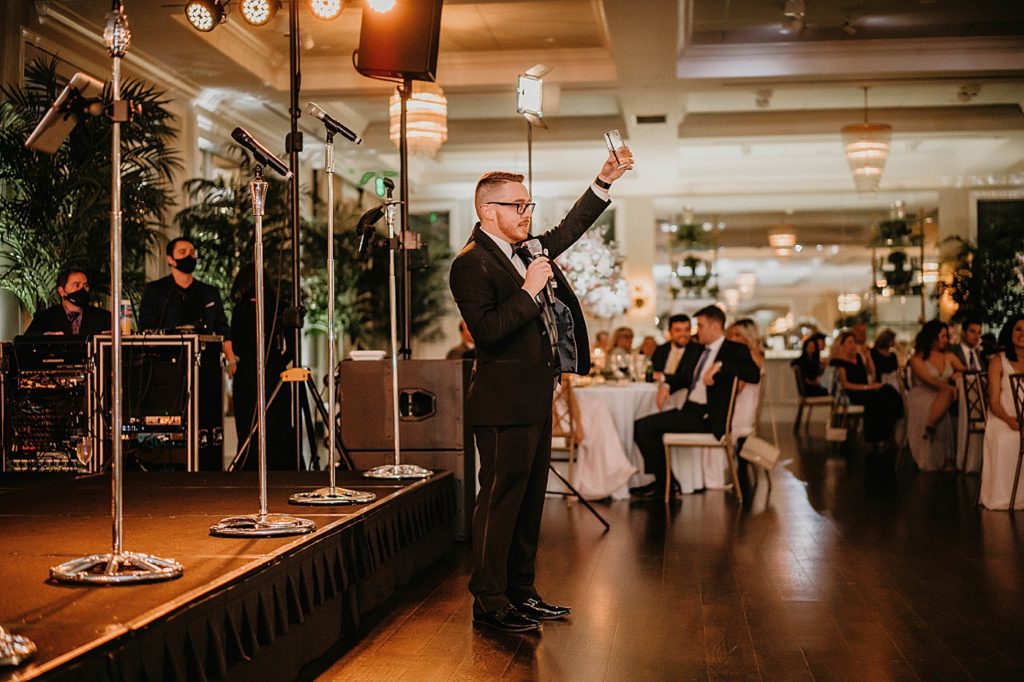 Best man speech and cheers at Reception Pelican Club Wedding Photography captured by South Florida Wedding Photographer Krystal Capone Photography