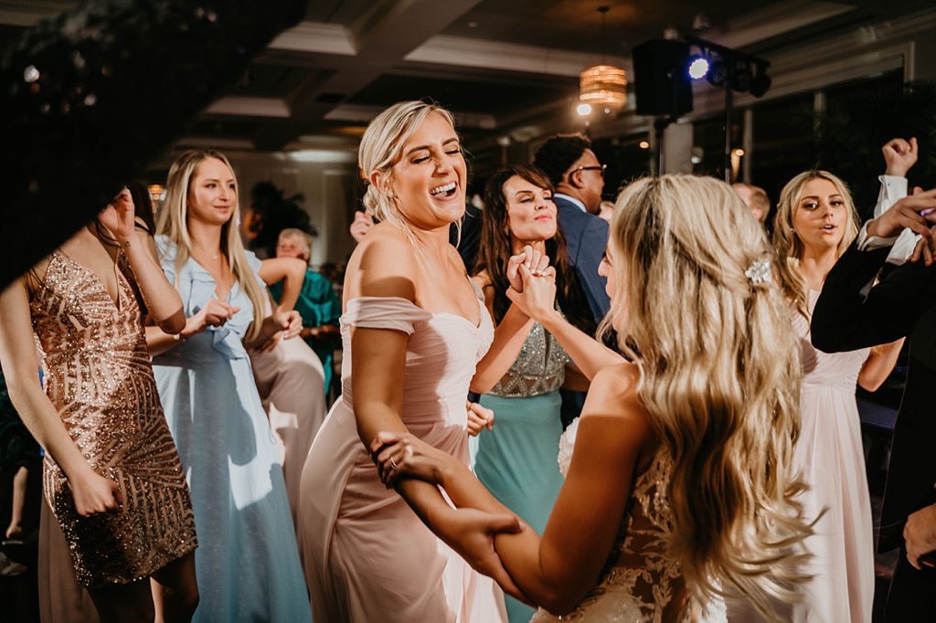 Bride and Bridesmaids dancing at Reception Pelican Club Wedding Photography captured by South Florida Wedding Photographer Krystal Capone Photography