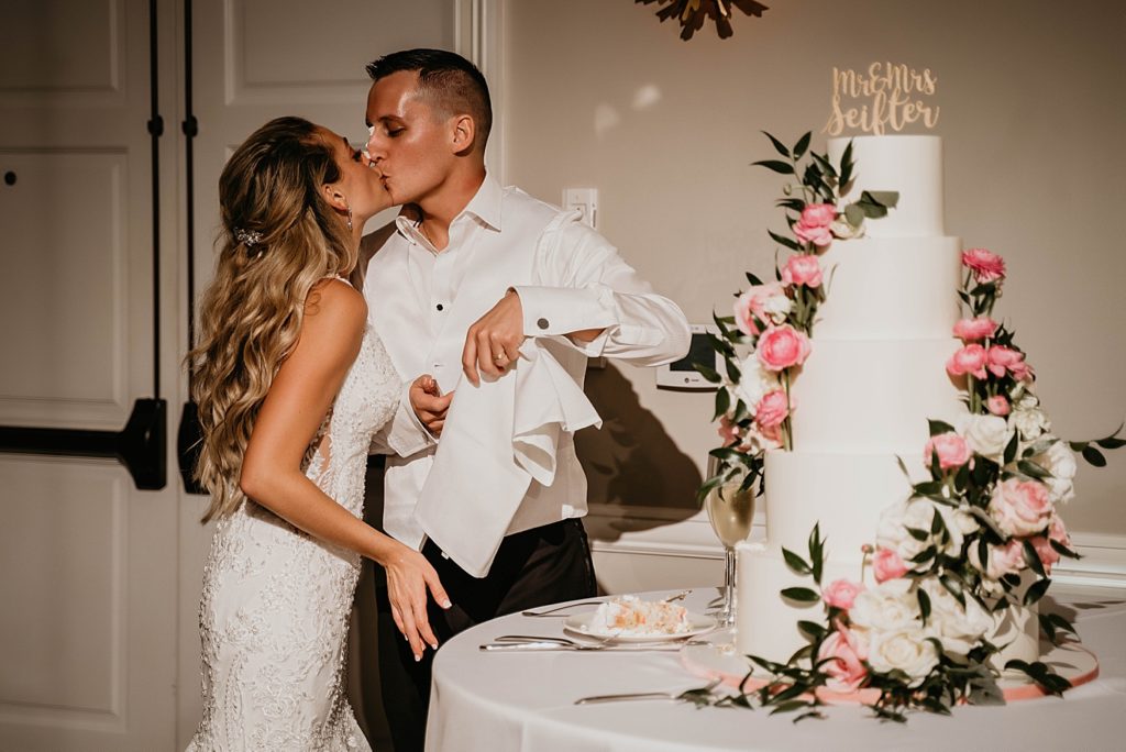 Bride and Groom kissing after cake cutting Reception Pelican Club Wedding Photography captured by South Florida Wedding Photographer Krystal Capone Photography