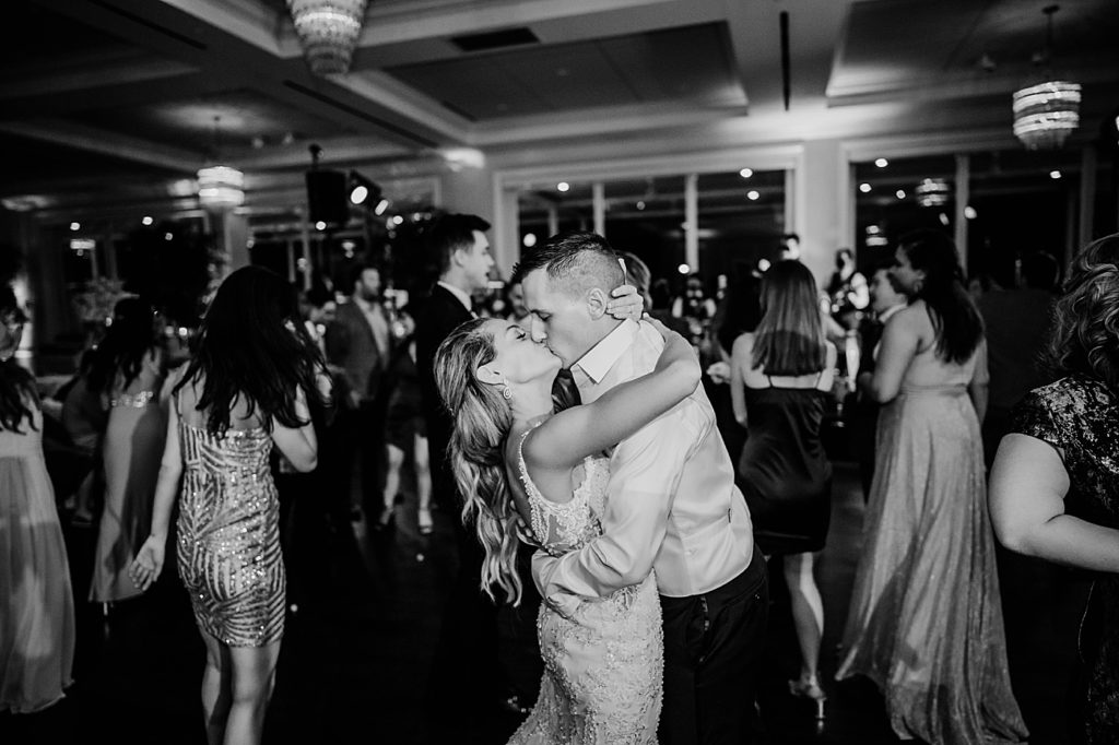 B&W Bride and Groom kissing at Reception Pelican Club Wedding Photography captured by South Florida Wedding Photographer Krystal Capone Photography