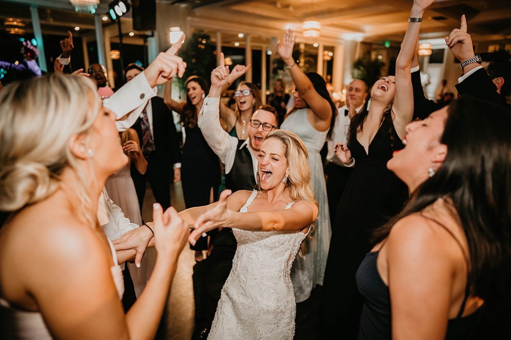 Bride dancing and having fun at Reception Pelican Club Wedding Photography captured by South Florida Wedding Photographer Krystal Capone Photography